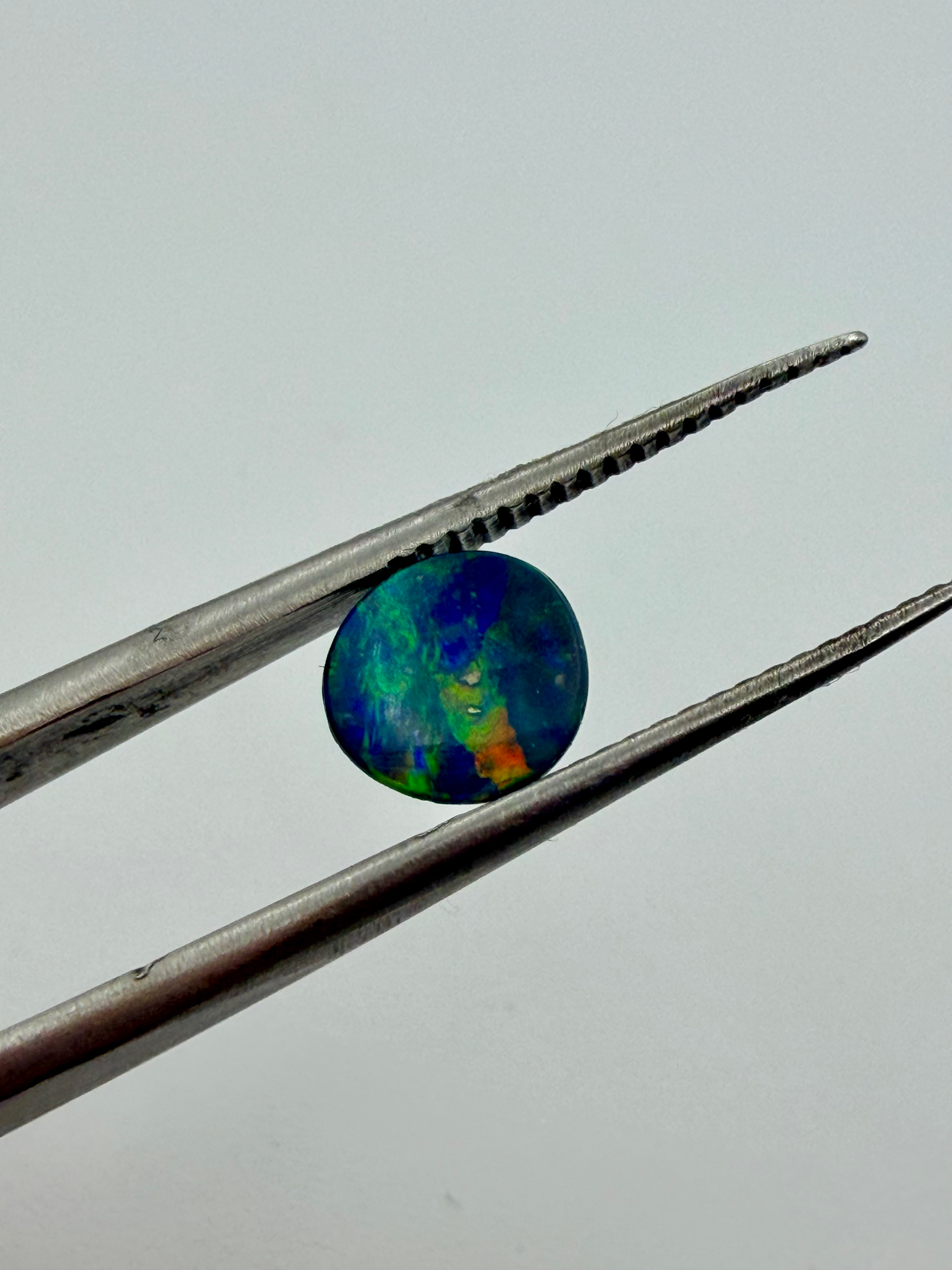 Opal Doublet Striking colours 7.2mm round 0.78cts image 3