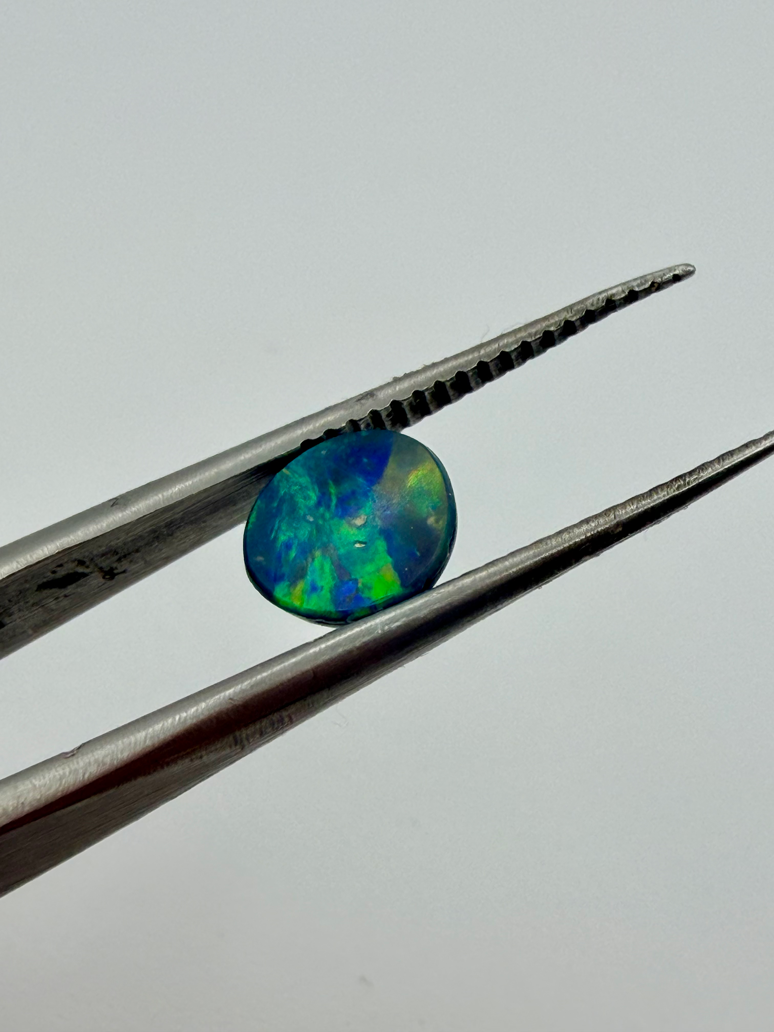 Opal Doublet Striking colours 7.2mm round 0.78cts image 4