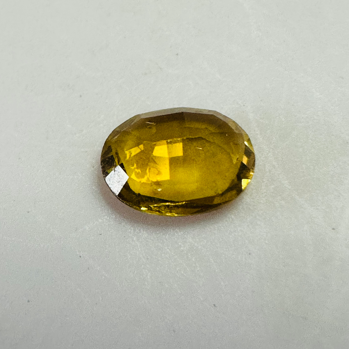 Tourmaline dark yellow oval 8.2x6.5mm 1.21cts