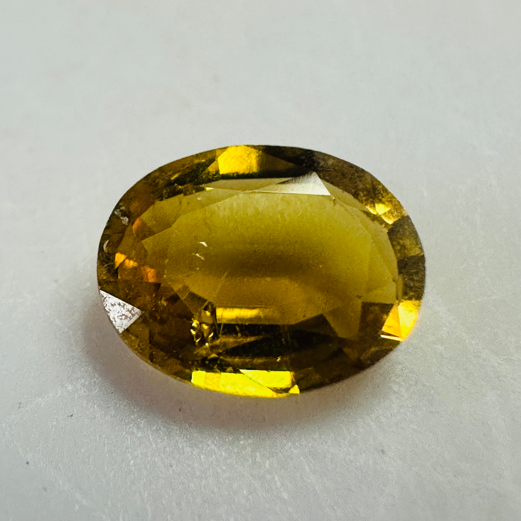 Tourmaline dark yellow oval 8.2x6.5mm 1.21cts